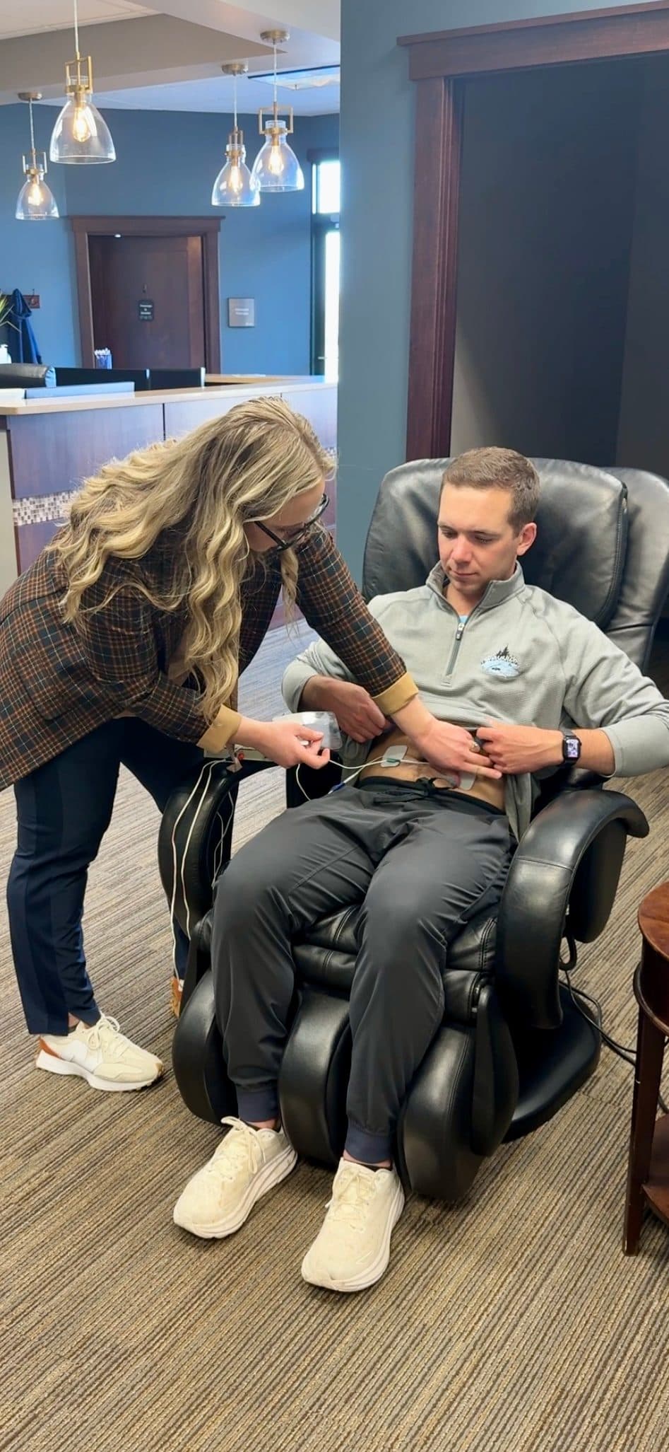 Dr. Maxa applying microcurrent therapy to a patient in the Savage, MN clinic